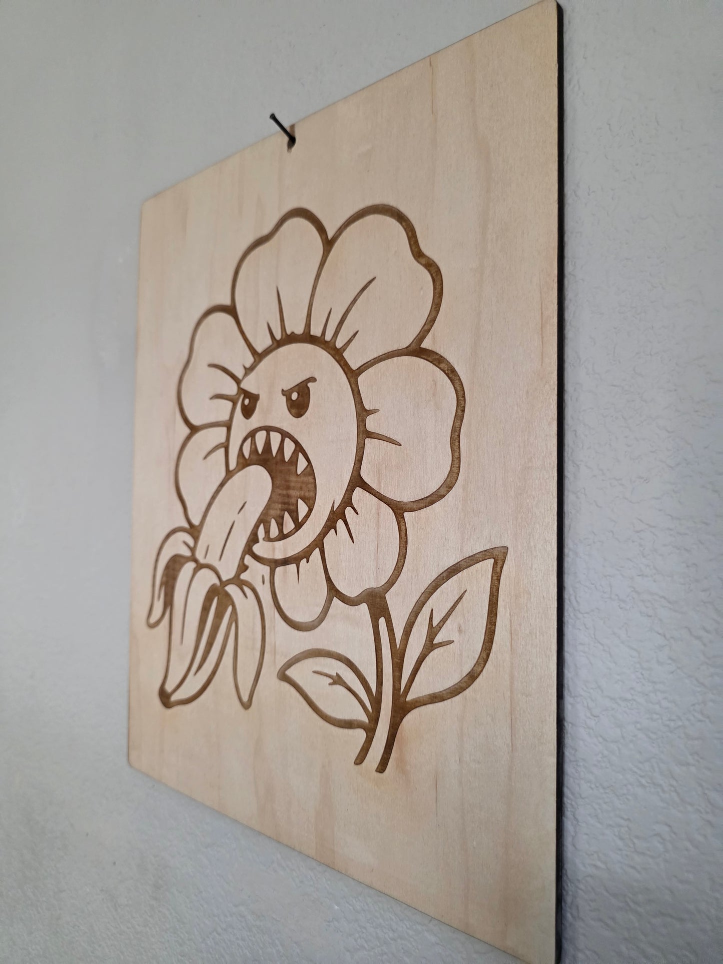 Angry Flower Eating a Banana – 11" x 17" Engraved Maple Wall Art