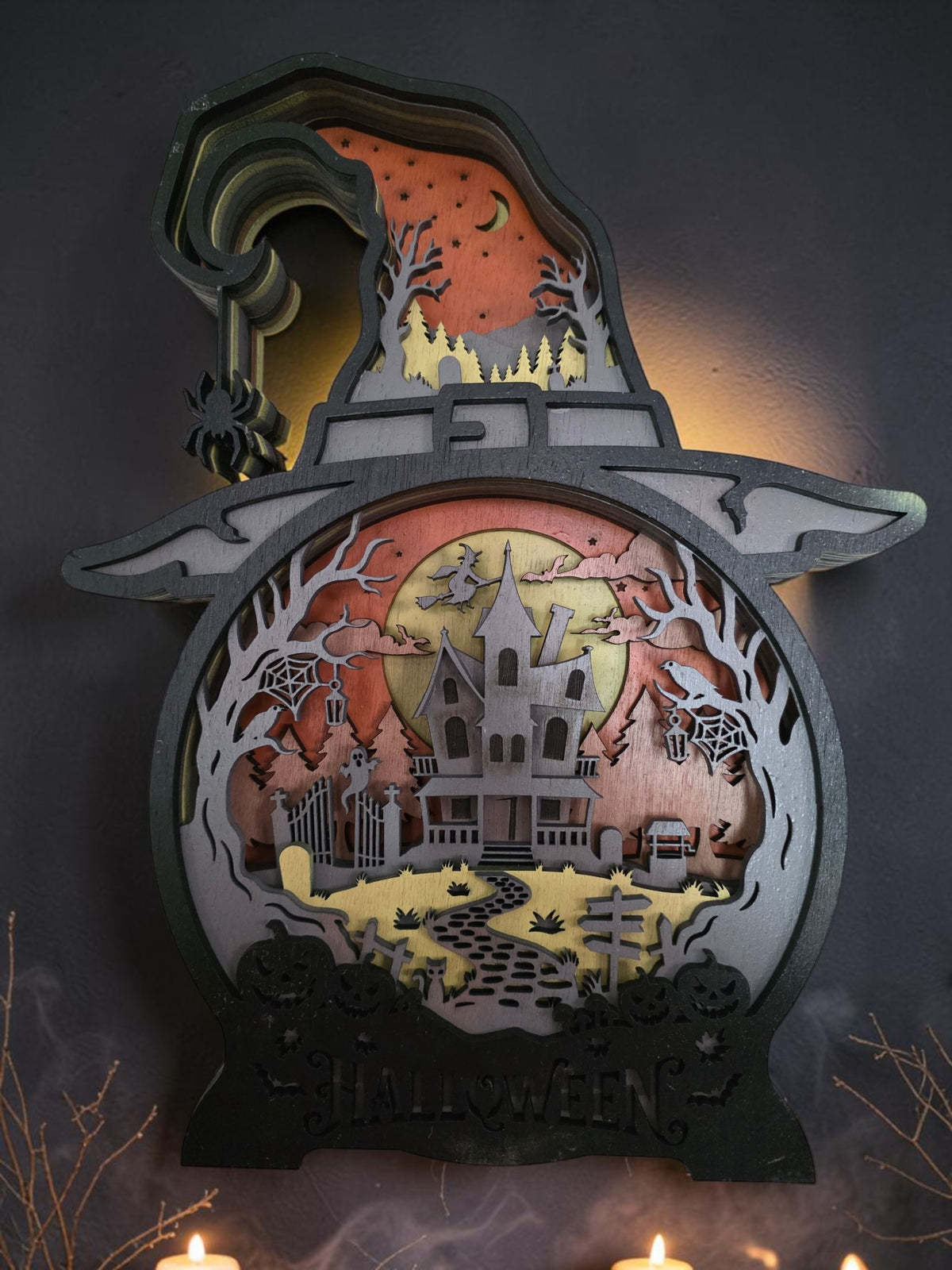 Layered wooden witch hat Halloween wall art with haunted house, moon, bats, ravens, spider webs, pumpkins, and spooky forest scene
