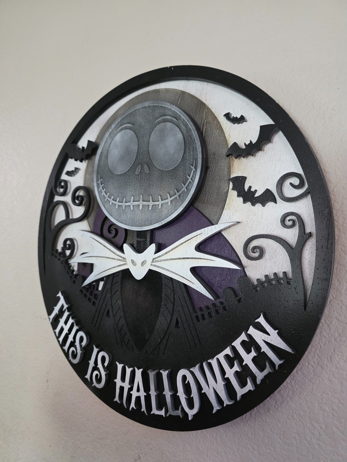 Angled close view of layered wooden This Is Halloween wall art showing dimensional stacked wood layers