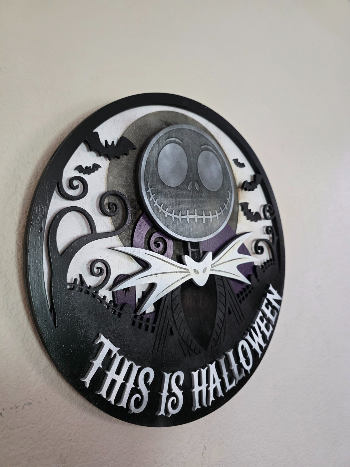 Side view of layered wooden This Is Halloween wall art showing dimensional wood construction